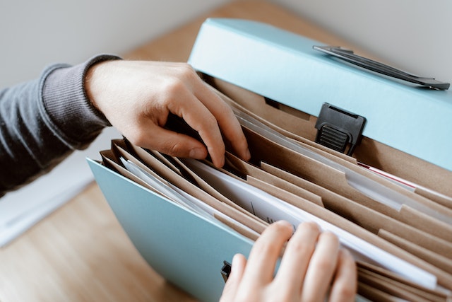 Person looking through documents in a file folder | Specialized Memphis Person looking through documents in a file folder