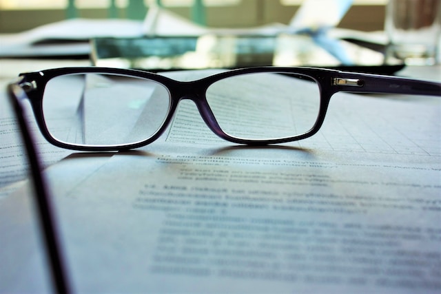 glasses set on top of a document on a desk | Specialized Memphis glasses set on top of a document on a desk