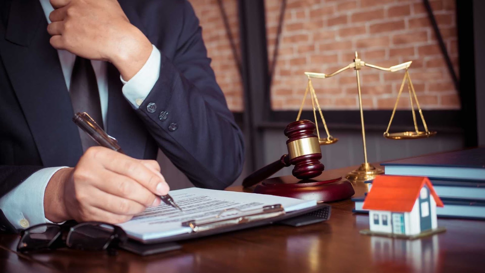 image-3 | Specialized Memphis Cropped image of a lawyer in a blue suit writing a legal contract with a fountain pen