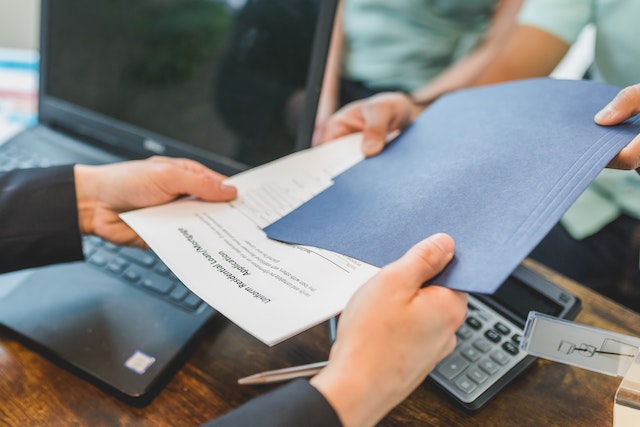 image | Specialized Memphis Hands exchanging documents across a desk