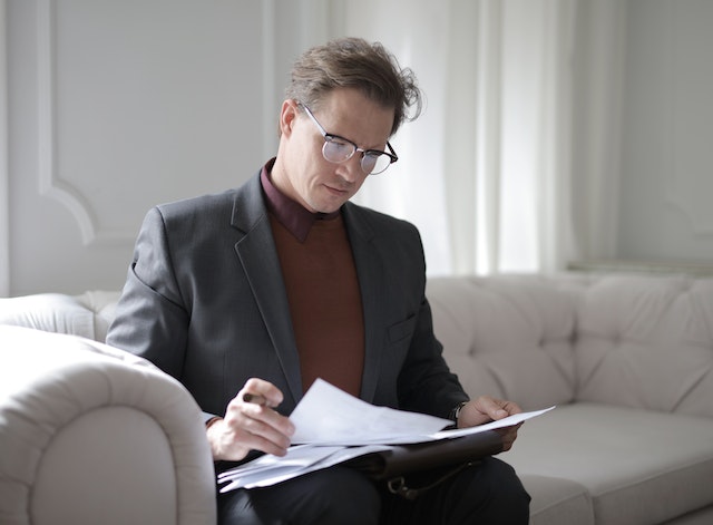 pexels-andrea-piacquadio-3760514 | Specialized Memphis Person reviewing documents on a couch