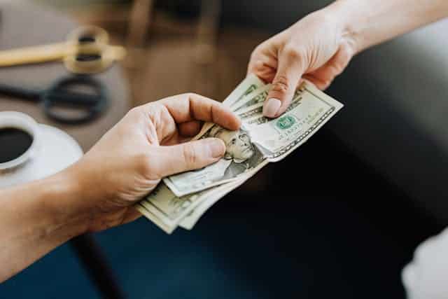 Hands Holding Us Dollar Bills | Specialized Memphis handling over money