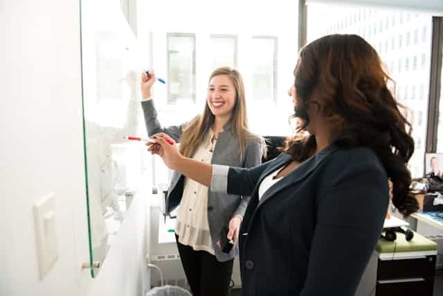 pexels-divinetechygirl-1181533 | Specialized Memphis two women in suits using a white board