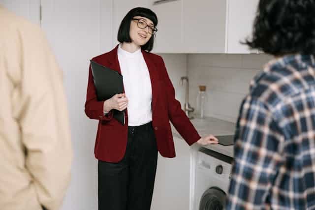 pexels-ivan-samkov-8962571 | Specialized Memphis woman in red blazer showing a couple a kitchen