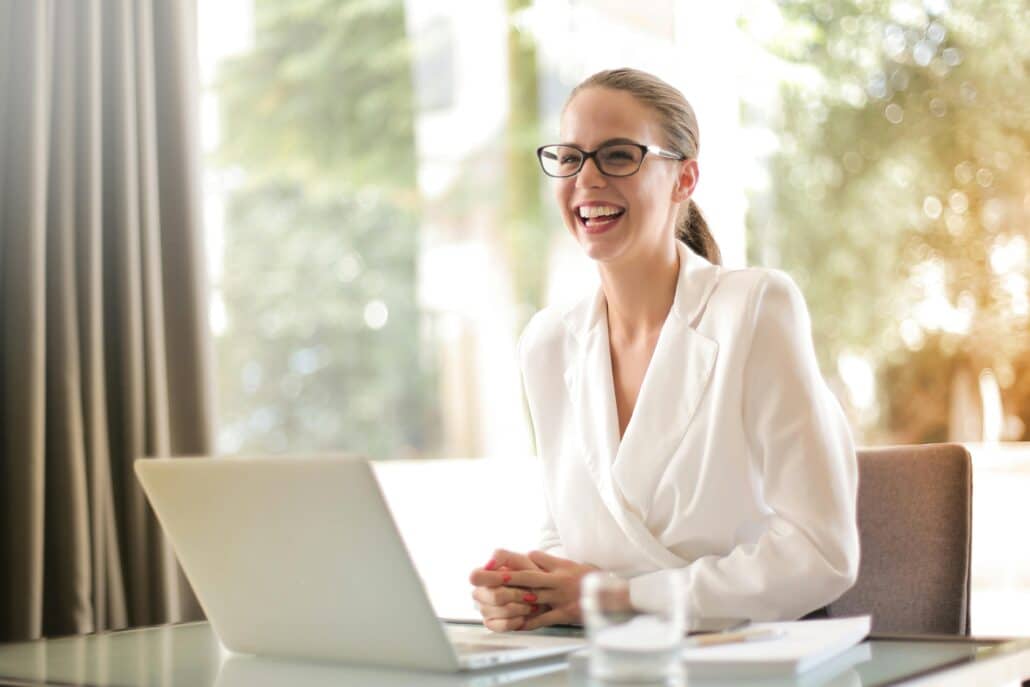 pexels-olly-3756679 5 | Specialized Memphis woman in white blouse and glasses in front of an open laptop